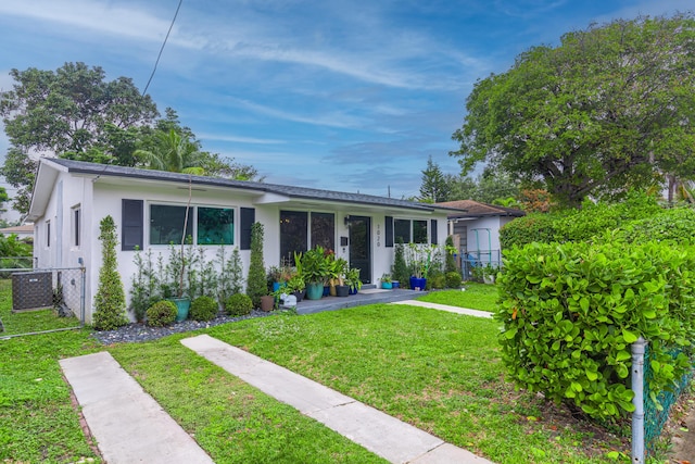 ranch-style house featuring central AC and a front yard