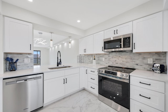 kitchen featuring white cabinets, marble finish floor, stainless steel appliances, recessed lighting, and a sink
