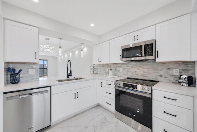 kitchen featuring appliances with stainless steel finishes, white cabinets, and sink