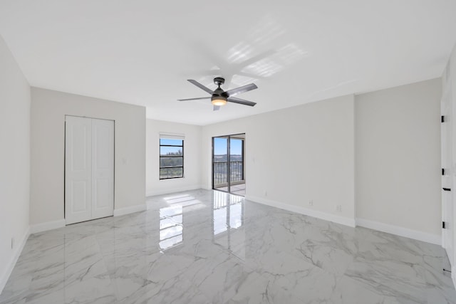 unfurnished bedroom featuring ceiling fan and a closet