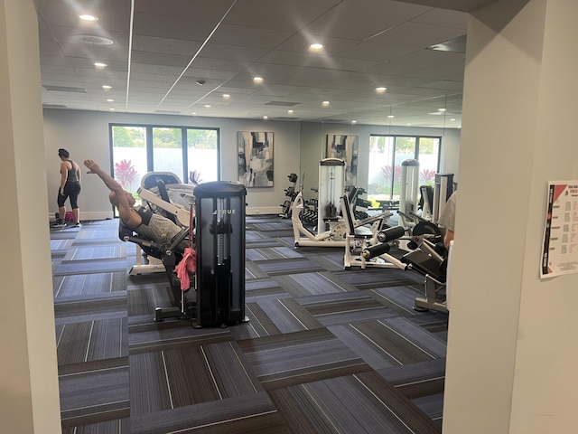 exercise room with dark colored carpet