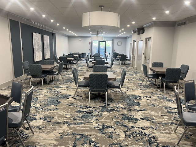 gym featuring a drop ceiling and carpet floors