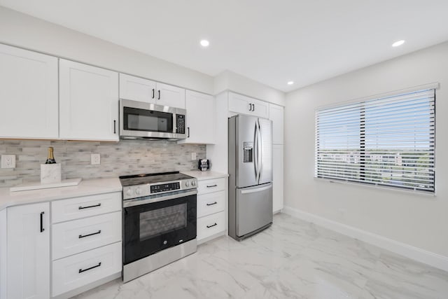 kitchen with white cabinets, backsplash, and stainless steel appliances