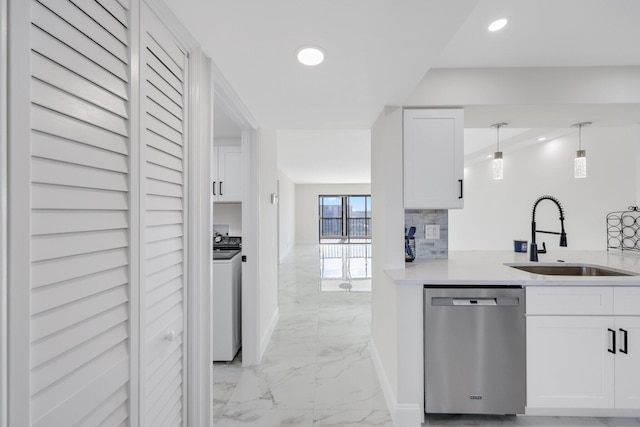 kitchen with washer / clothes dryer, dishwasher, sink, and white cabinetry