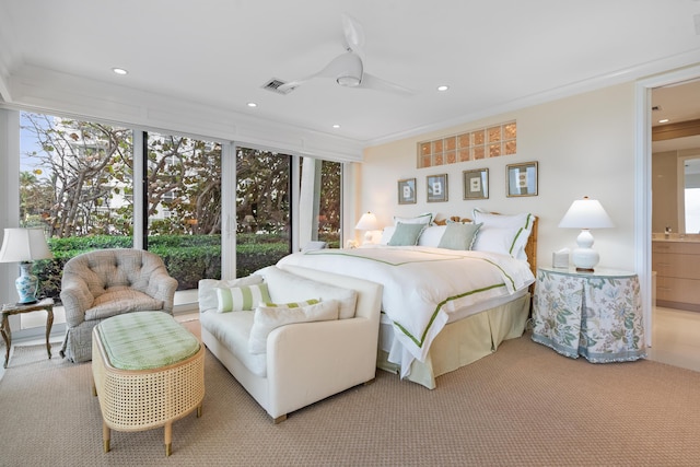 carpeted bedroom with ceiling fan, connected bathroom, and ornamental molding