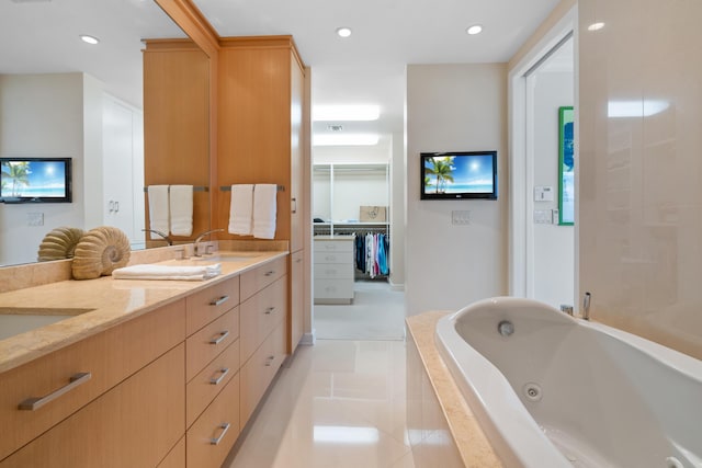 bathroom with vanity, tile patterned floors, and tiled tub