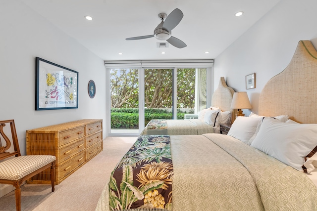 carpeted bedroom featuring ceiling fan and floor to ceiling windows