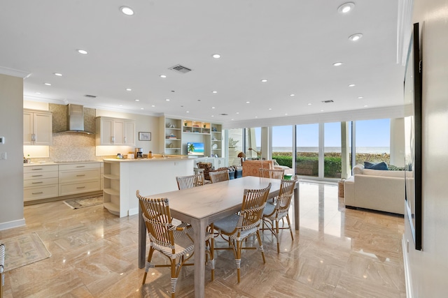 dining space featuring crown molding