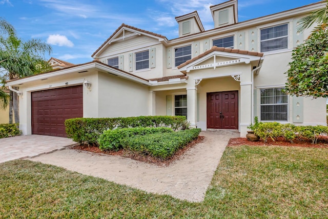 view of property featuring a front lawn and a garage