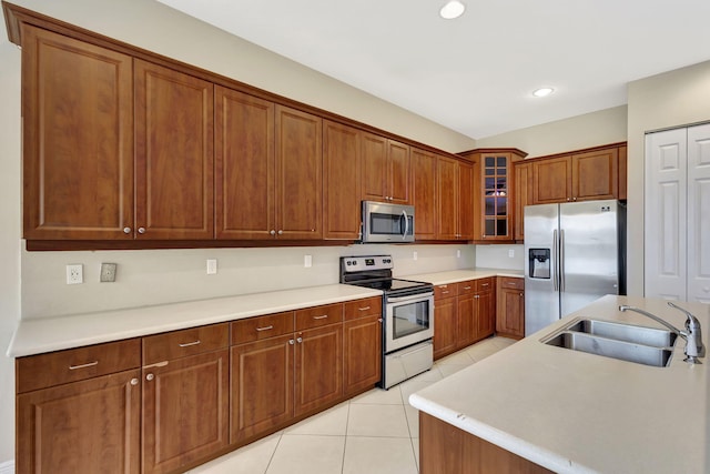 kitchen featuring sink, light tile patterned floors, and stainless steel appliances