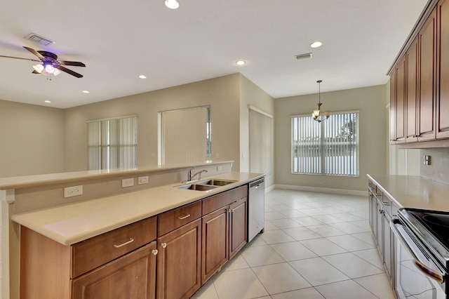 kitchen featuring appliances with stainless steel finishes, decorative light fixtures, light tile patterned flooring, ceiling fan with notable chandelier, and sink