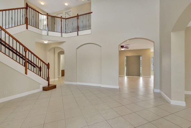 tiled entrance foyer featuring a high ceiling