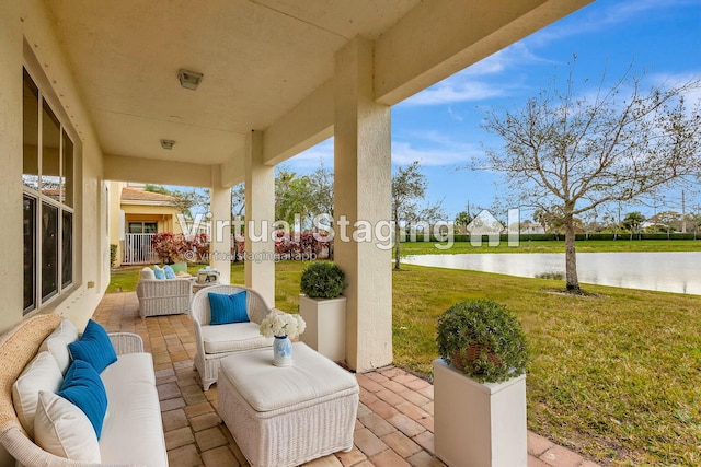 view of patio with a water view and an outdoor living space