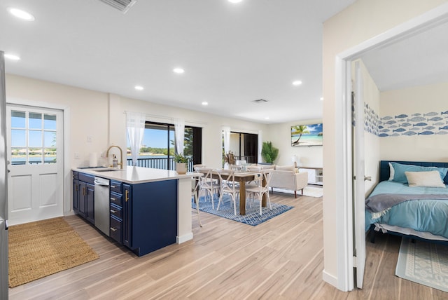 kitchen featuring blue cabinets, kitchen peninsula, and light wood-type flooring