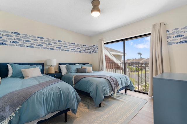 bedroom featuring light hardwood / wood-style floors and access to outside