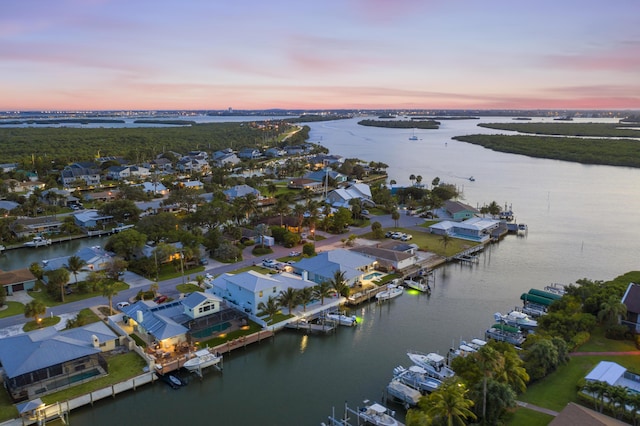 aerial view at dusk with a water view