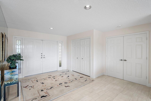 foyer entrance featuring plenty of natural light and a textured ceiling