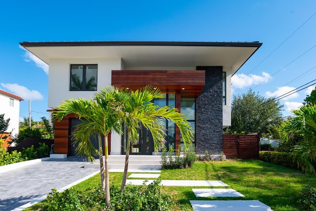 contemporary house with a front lawn