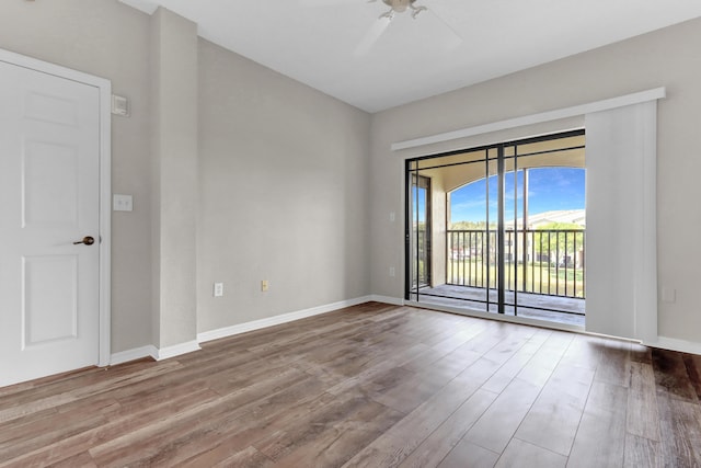 spare room with ceiling fan and wood-type flooring