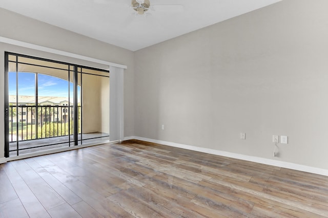 spare room featuring light wood-type flooring and ceiling fan