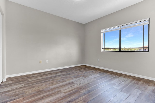 unfurnished room featuring hardwood / wood-style flooring