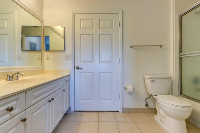 full bathroom featuring toilet, bath / shower combo with glass door, tile patterned floors, and vanity