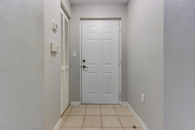 doorway to outside featuring light tile patterned flooring