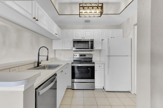 kitchen with white cabinetry, stainless steel appliances, sink, hanging light fixtures, and light tile patterned floors