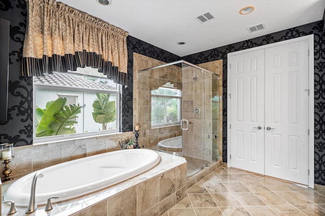 bathroom featuring independent shower and bath