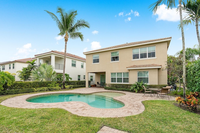 view of pool with a lawn and a patio