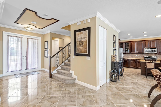 entrance foyer with french doors and crown molding