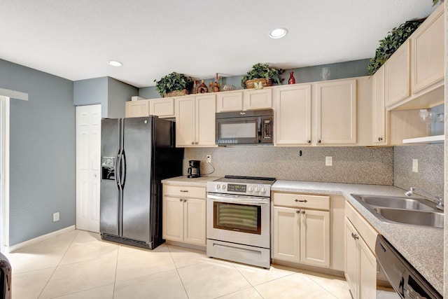 kitchen featuring black appliances, backsplash, sink, and light tile patterned flooring