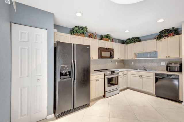 kitchen featuring light tile patterned floors, sink, backsplash, and black appliances