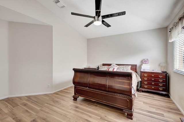 bedroom featuring ceiling fan, light hardwood / wood-style floors, and lofted ceiling