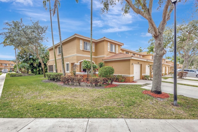 mediterranean / spanish house with a garage and a front yard