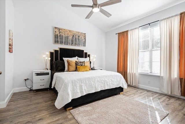 bedroom featuring lofted ceiling, hardwood / wood-style floors, and ceiling fan