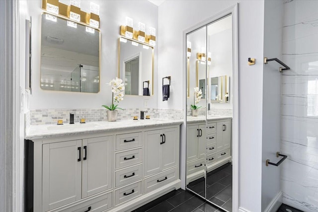 bathroom featuring vanity, backsplash, and tile patterned flooring