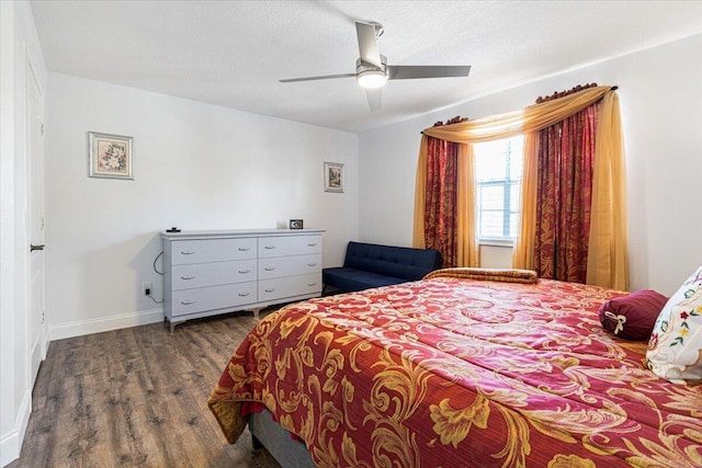 bedroom with dark wood-type flooring and ceiling fan