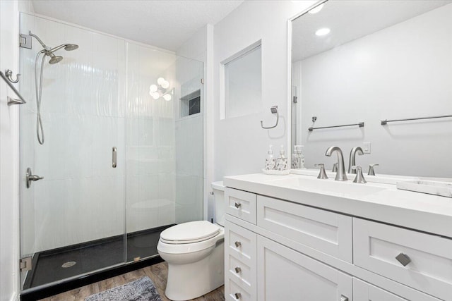 bathroom featuring vanity, hardwood / wood-style floors, toilet, and an enclosed shower