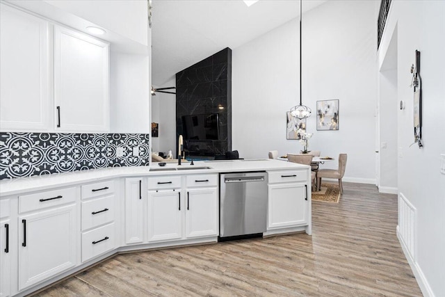 kitchen with sink, stainless steel dishwasher, pendant lighting, ceiling fan, and white cabinets