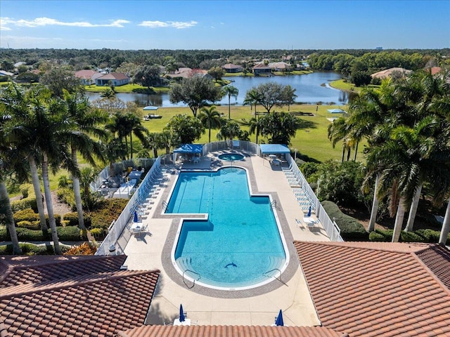 view of pool featuring a patio and a water view