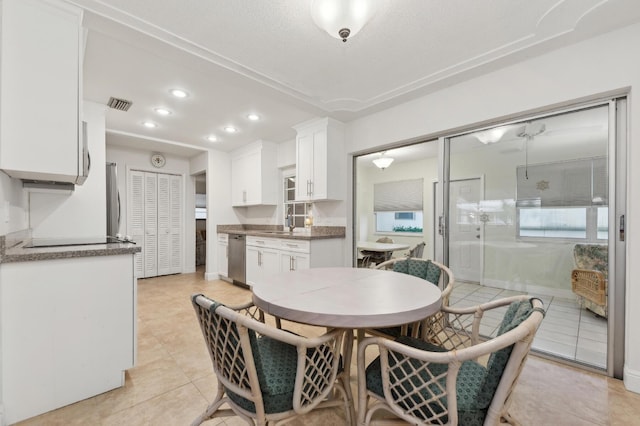 dining area with sink and light tile patterned floors