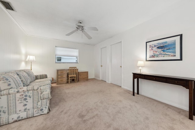 living area featuring ceiling fan and light colored carpet