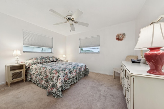 bedroom featuring ceiling fan and light carpet