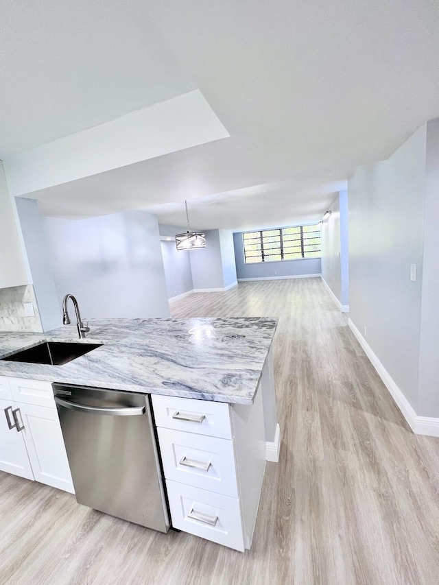 kitchen with light stone countertops, pendant lighting, white cabinets, dishwasher, and sink