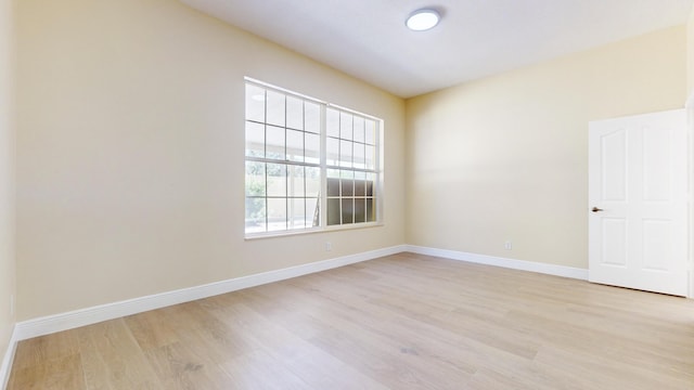 unfurnished room with light wood-type flooring