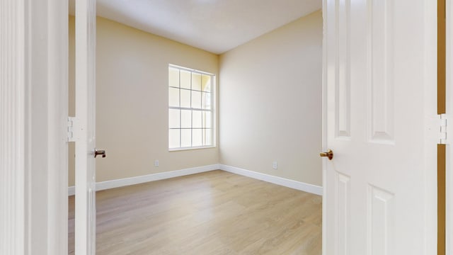 unfurnished room with light hardwood / wood-style floors