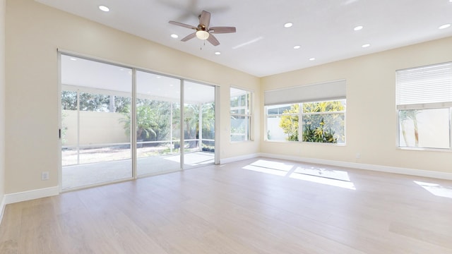 unfurnished room with ceiling fan and light wood-type flooring