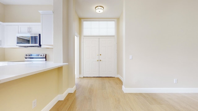 foyer with light hardwood / wood-style floors