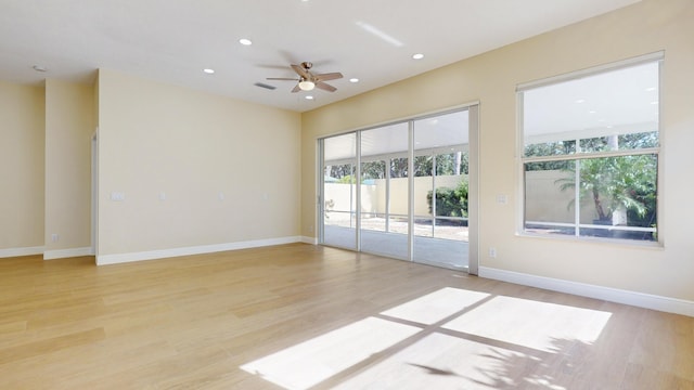 unfurnished room with ceiling fan and light hardwood / wood-style floors